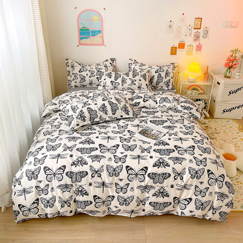 Black and white bedding with a butterfly pattern in a cozy room