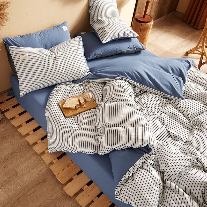 blue bedding sets with blue and white striped bedding, a wooden headboard, and a breakfast tray