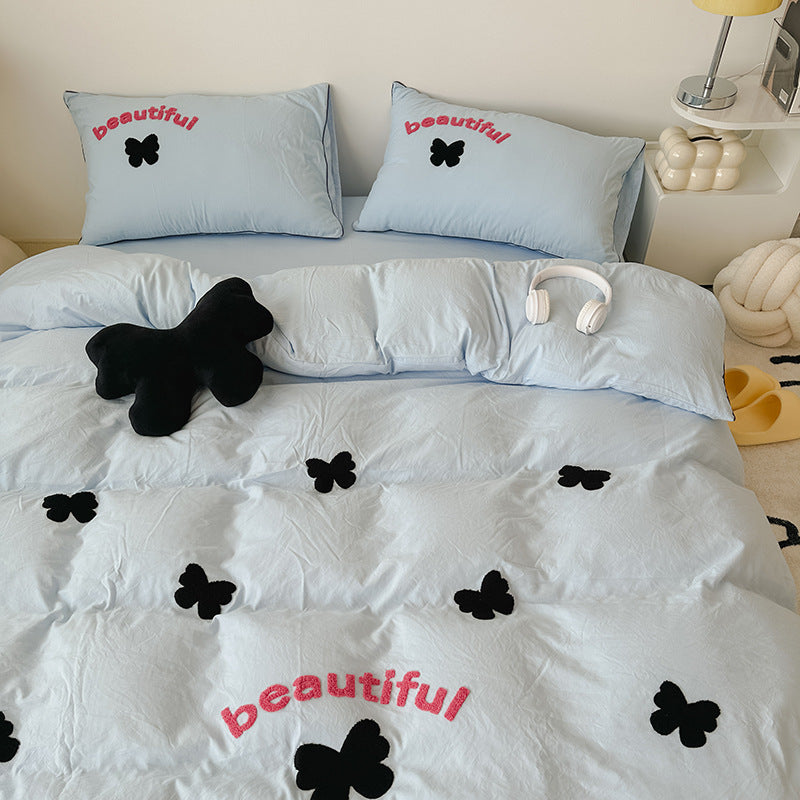 Soft light blue bedding with black butterfly designs and "beautiful" text