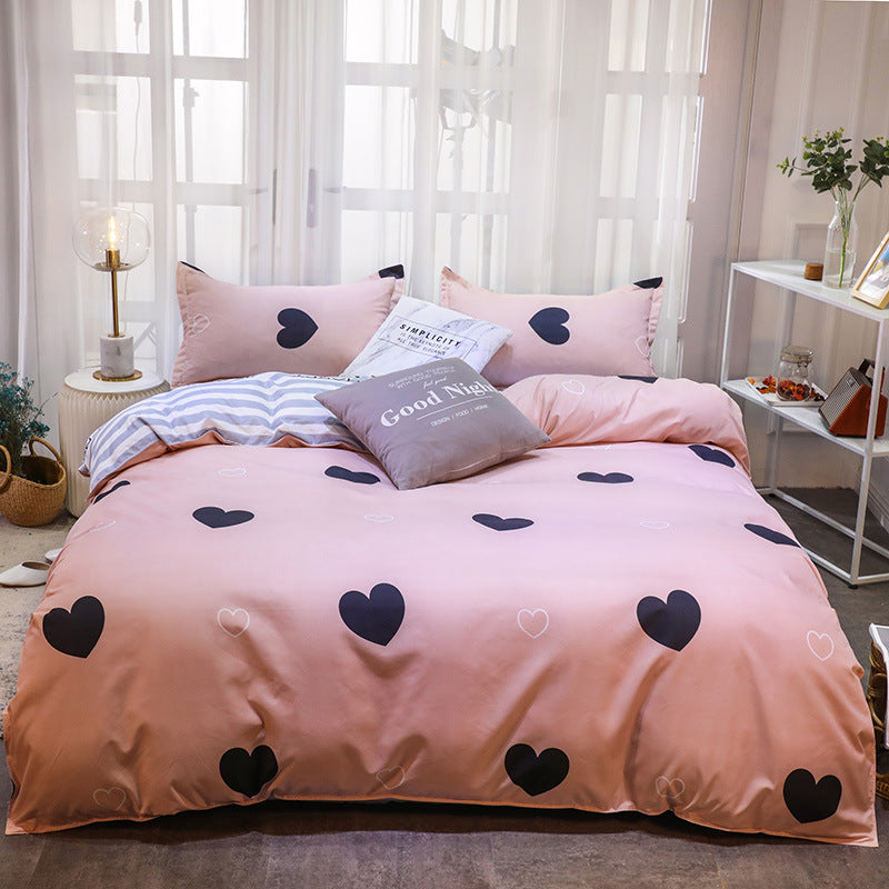 Elegant pink bedding set with black heart patterns and soft pillows