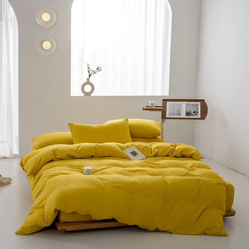 Vibrant yellow bedding set with pillows and a book