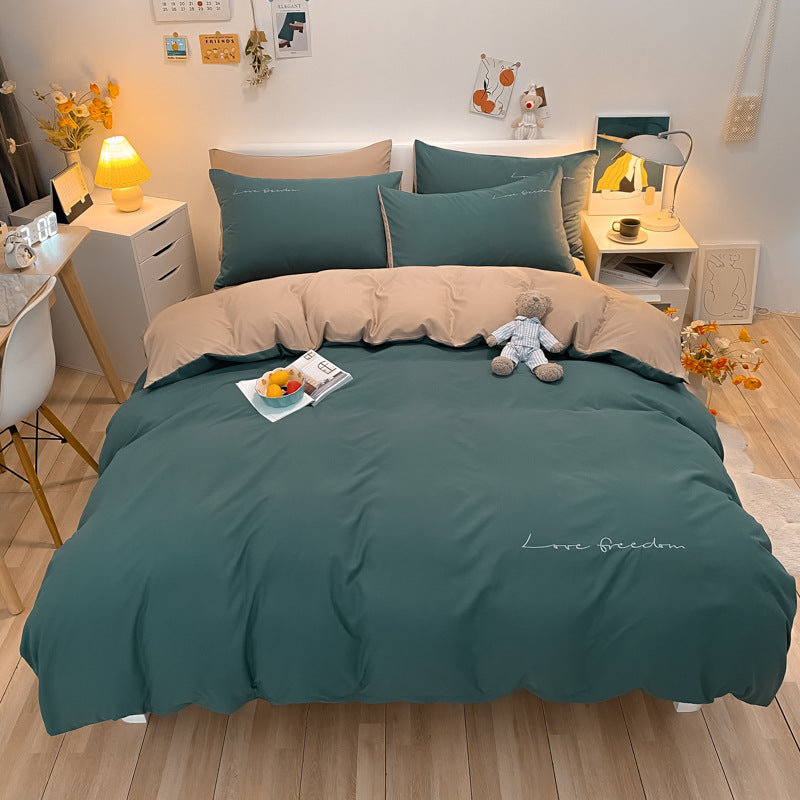 Cozy dark green bedding set with beige pillowcases in a warm bedroom