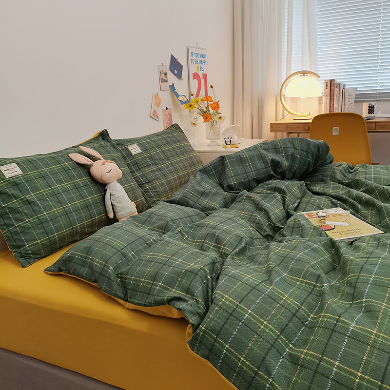 Cozy dark green plaid bedding set with yellow fitted sheet in a stylish bedroom