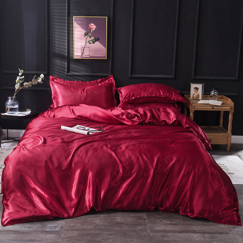 Elegant deep red satin bedding set with matching pillows