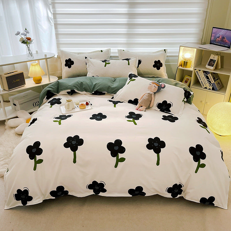 Modern black flower print bedding set on a white background