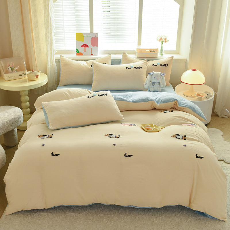 Cute beige bedding set with embroidered puppies and playful design