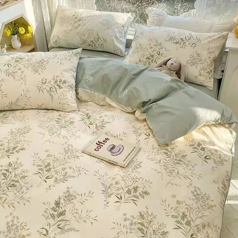 Green and beige bedding with a floral pattern and matching pillows