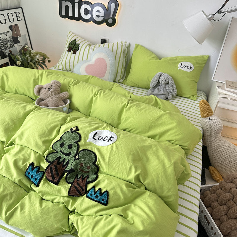 Green bedding set with cute embroidered ice cream designs and 'Luck' text