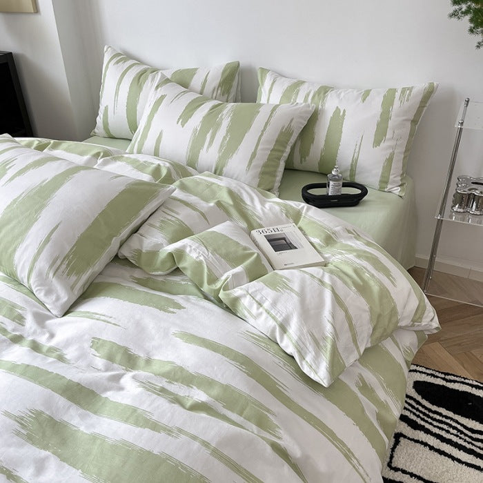 Bedding set with green brushstroke pattern on white background