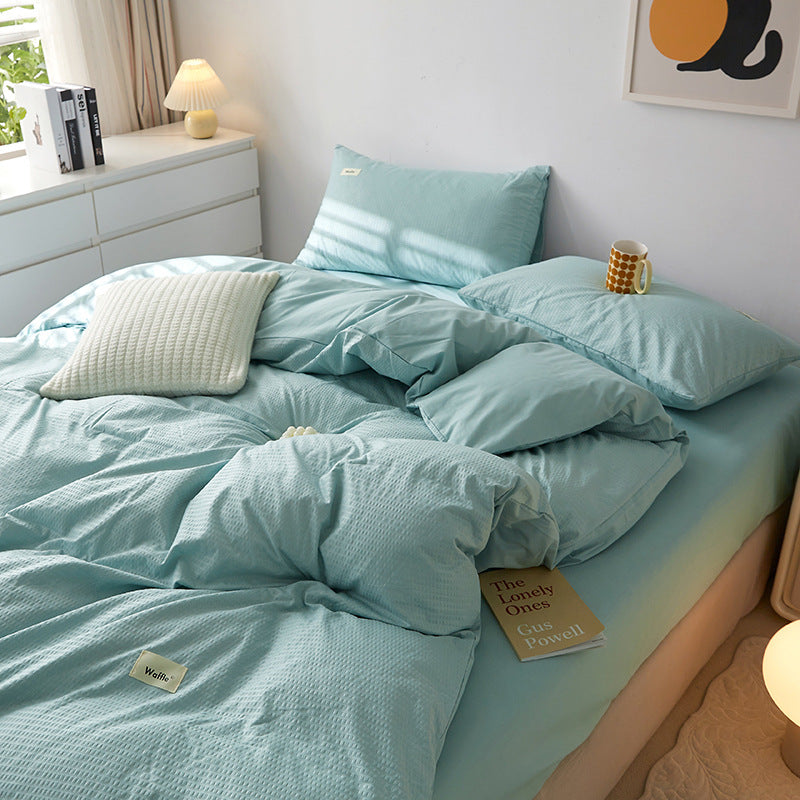 Soft light blue bedding set with textured fabric and pillows