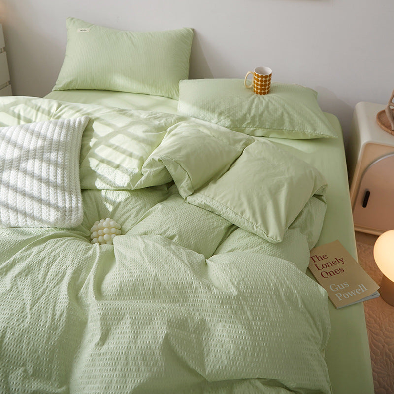 Soft light green bedding set with textured design and pillows