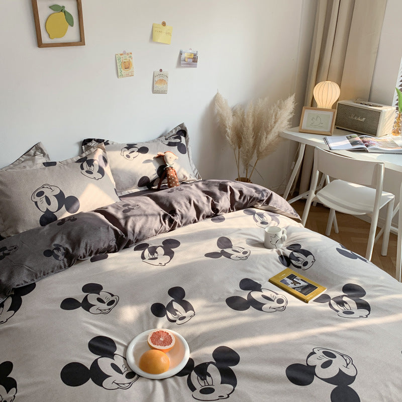 Grey bedding with a playful Mickey Mouse design and matching pillows