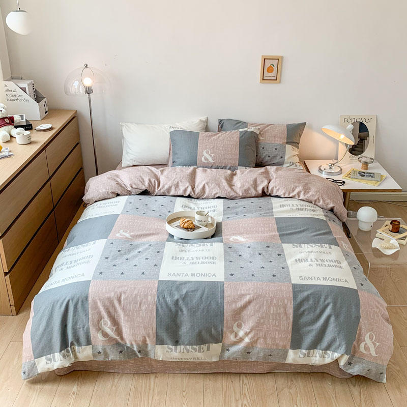 Stylish patchwork bedding in soft gray and pink with text design