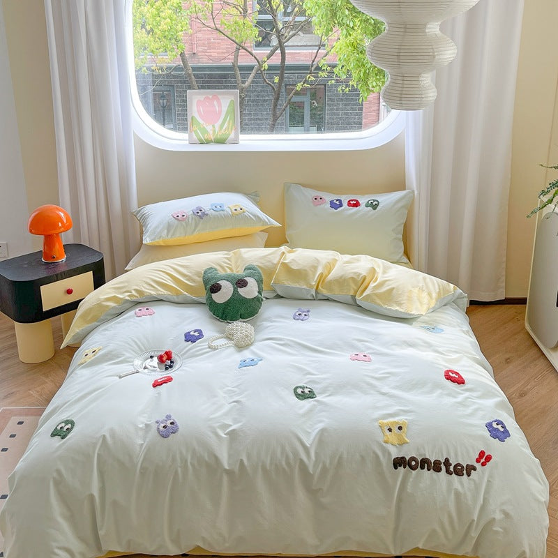 Cute monster-themed bedding with colorful monsters and yellow accents