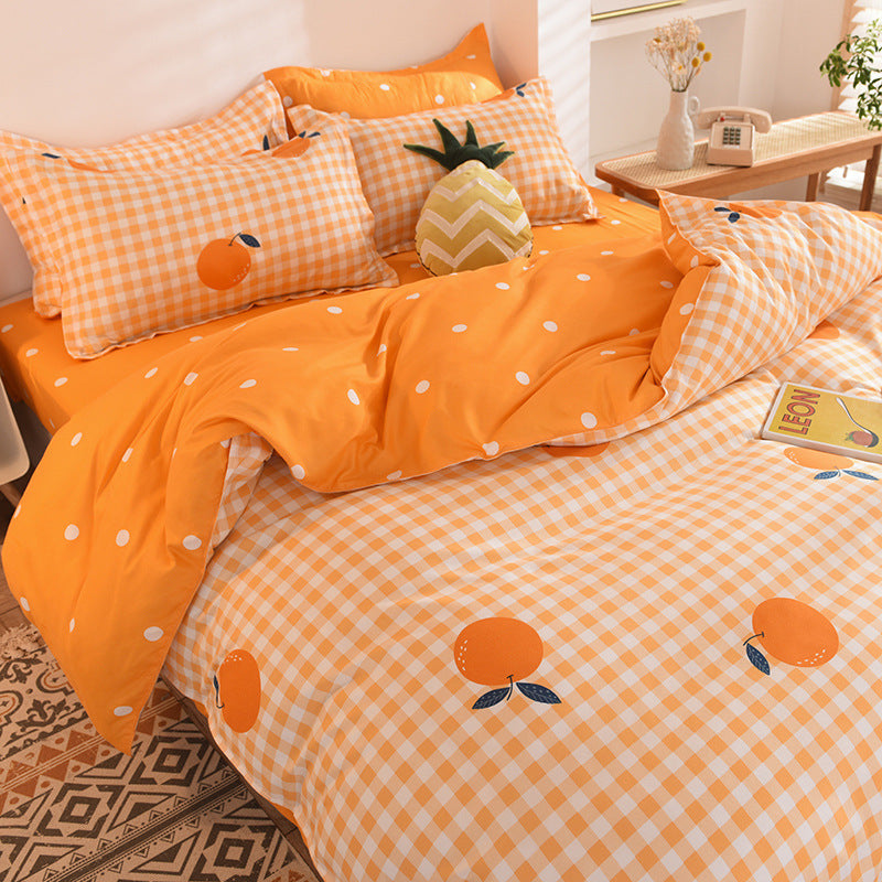 Vibrant orange bedding with gingham pattern and citrus prints