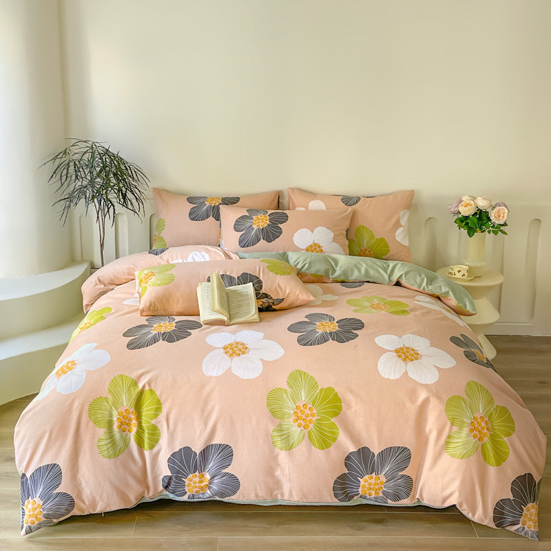 Soft peach bedding with oversized floral prints in green and black