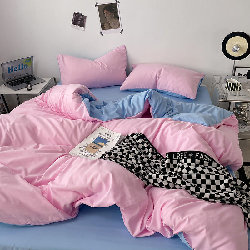 Soft pink and blue bedding set with cozy pillow arrangement