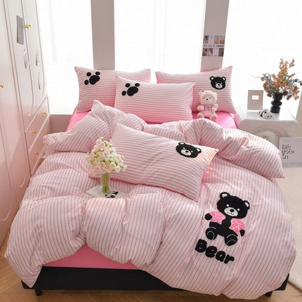 Pink striped bedding set with cute bear design and decorative pillows