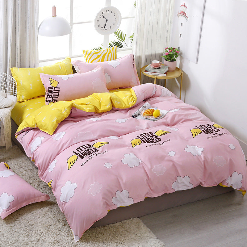 Soft pink and yellow bedding with angel wings and cloud prints