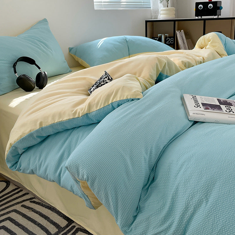 Modern blue and beige bedding with a textured fabric design