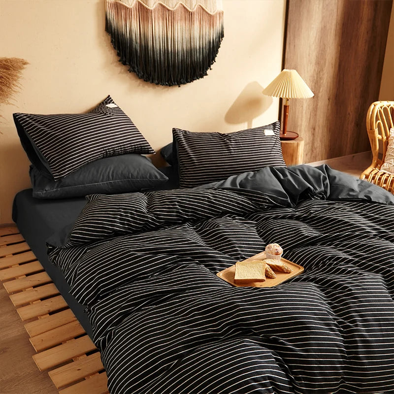 Elegant black bedding set with thin white stripes in cozy decor