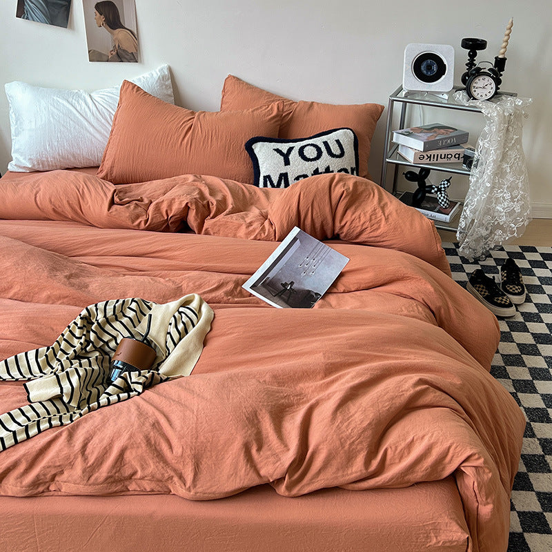 Terracotta orange bedding set with white pillows and cozy decor