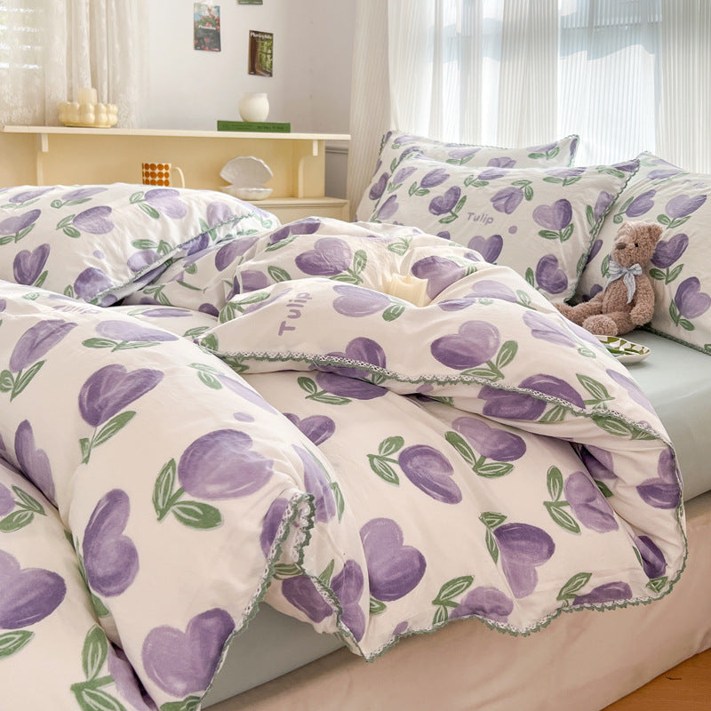 White bedding with a purple tulip pattern and green accents