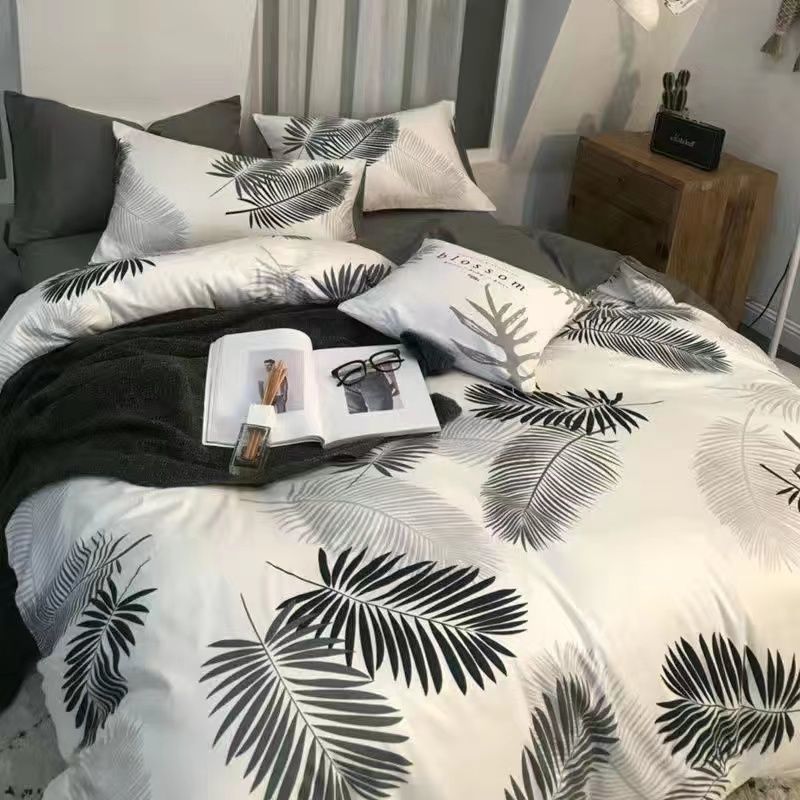 Bedding set with black palm leaf design on a white background