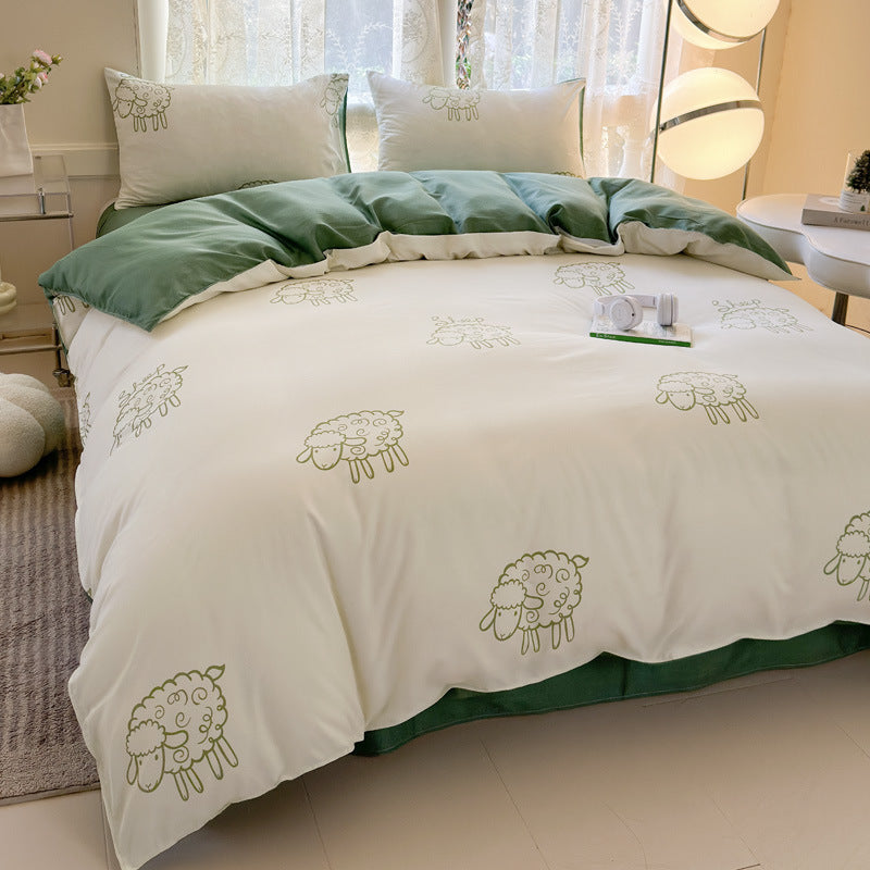 Soft white bedding featuring minimalist green sheep illustrations