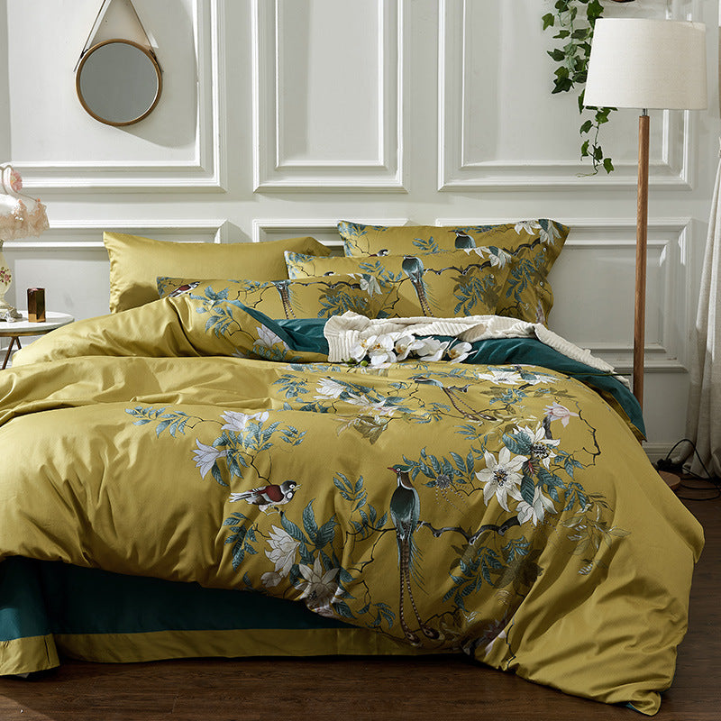 Elegant yellow bedding set featuring birds and floral patterns