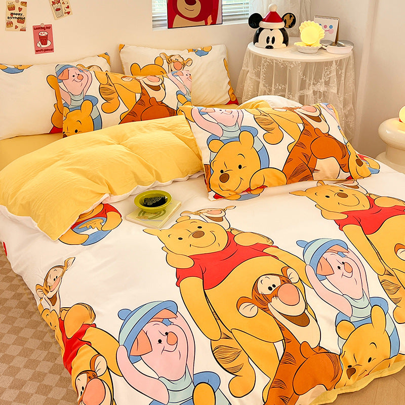 Cheerful yellow bedding with playful cartoon animals and warm tones