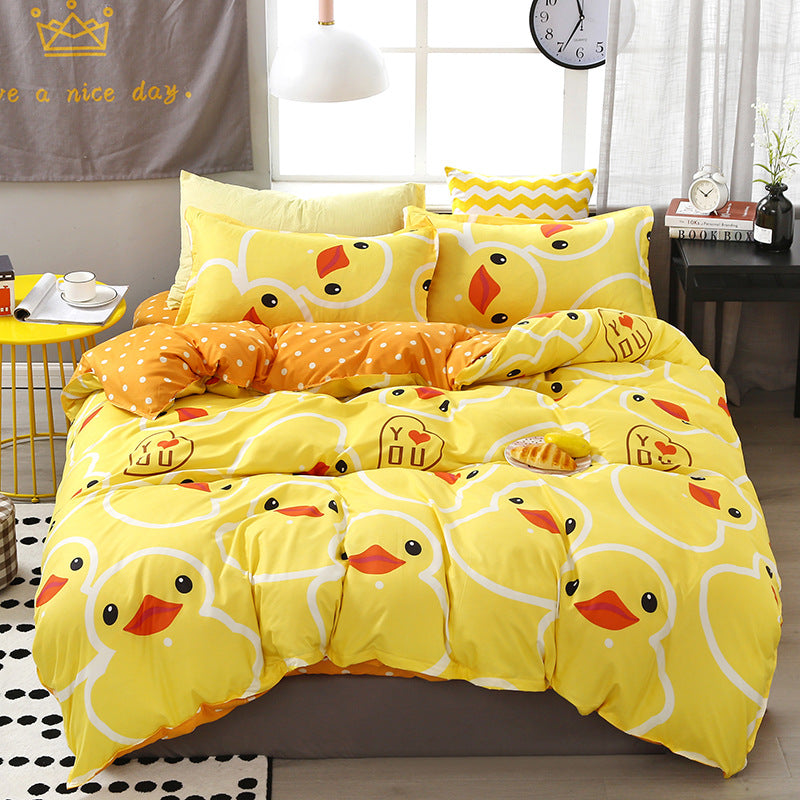 Bright yellow bedding set with cute duck pattern and orange accents