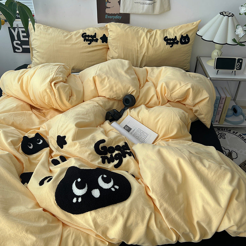 Cozy yellow bedding with cute black cat pattern and "Good night" text