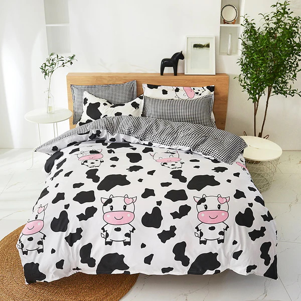 Fun black and white cow print bedding with pink accents