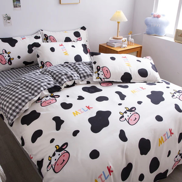 Fun cow-themed bedding with black spots and cute cartoon cows