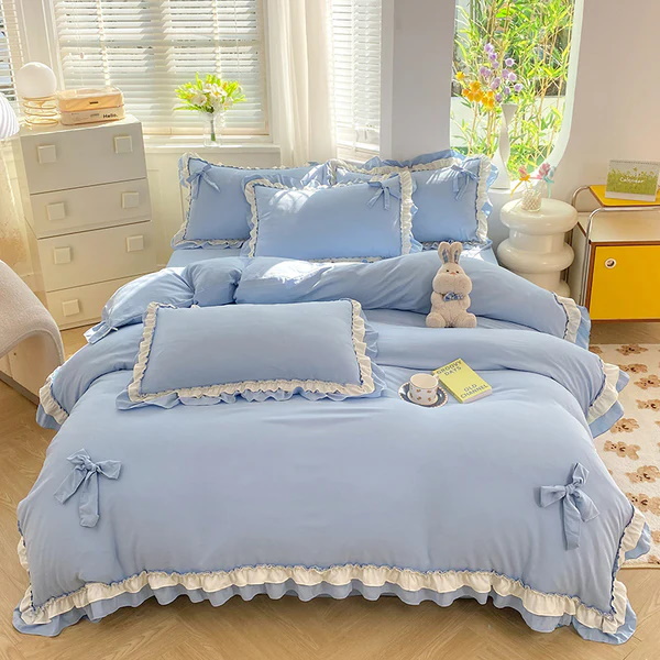 Blue bedding set with frills and bows on pillows and duvet