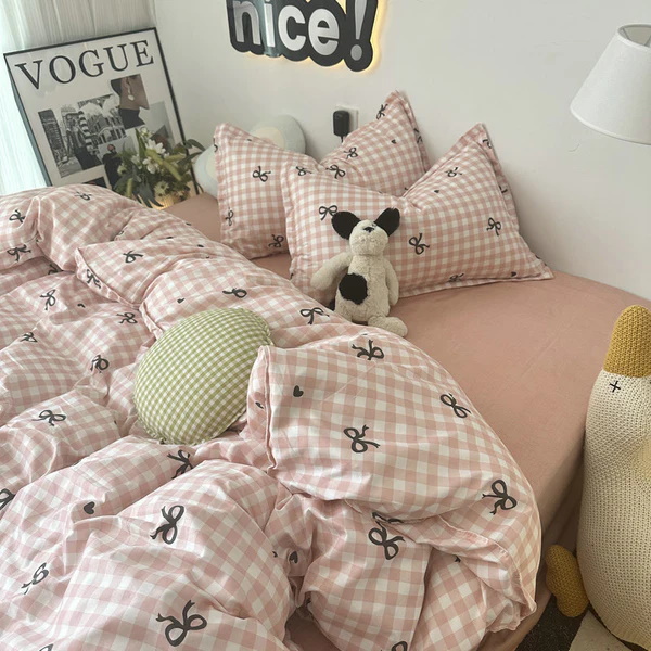 Pink checkered bedding with bow print and soft pillows